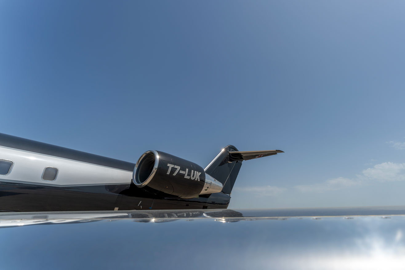 Bikini Technic aircraft tail T7-LUK against a dramatic sunset sky